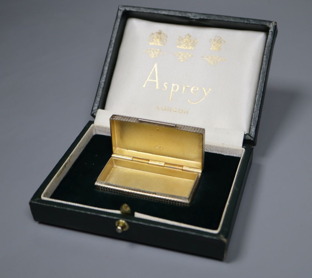 A modern cased Asprey & Co silver pill box, 51mm, a Jensen gilt sterling 1977 spoon and two servers.